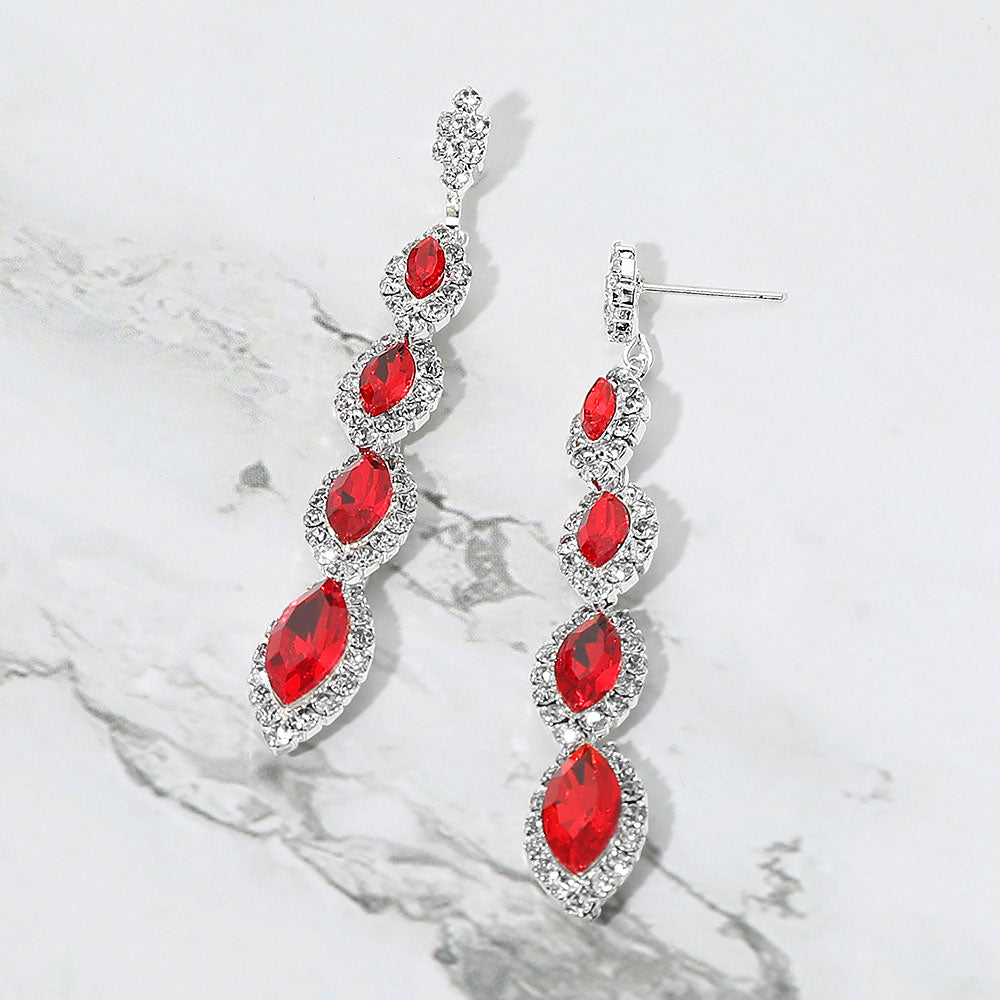 Red vintage marquise stone link drop formal evening earrings on silver with rhinestones on white marble background