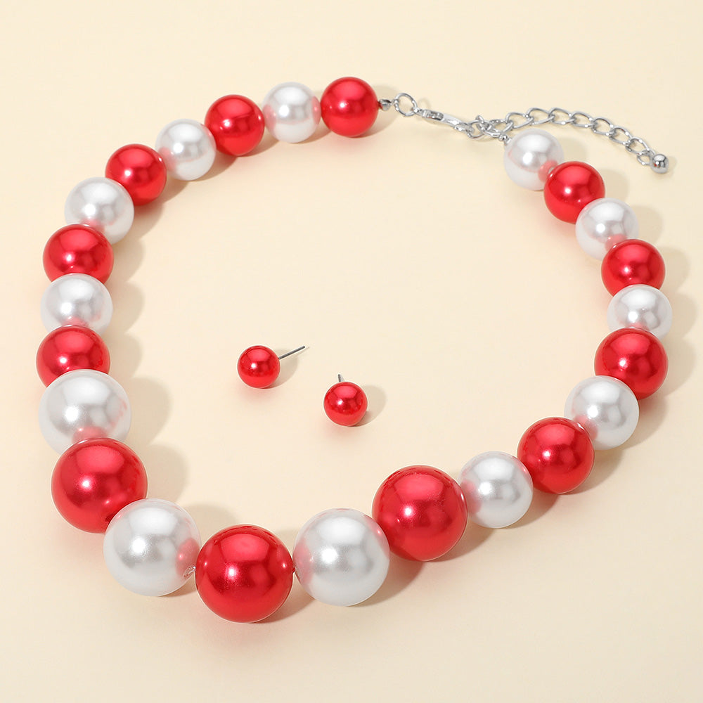 Red and White oversized pearl statement necklace set with large round beads and matching red stud earrings, displayed on a light cream background.