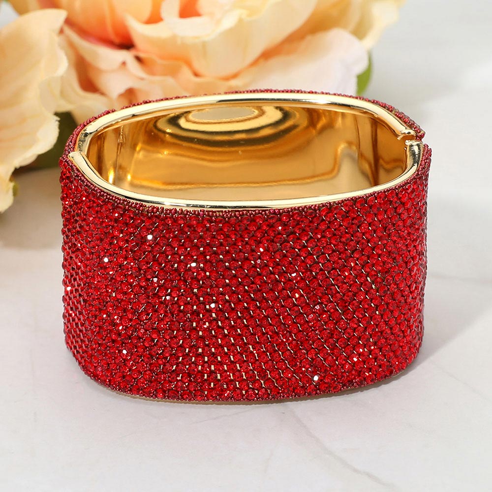 Red wide rhinestone hinged bangle bracelet with a chunky statement silhouette and polished gold-tone setting