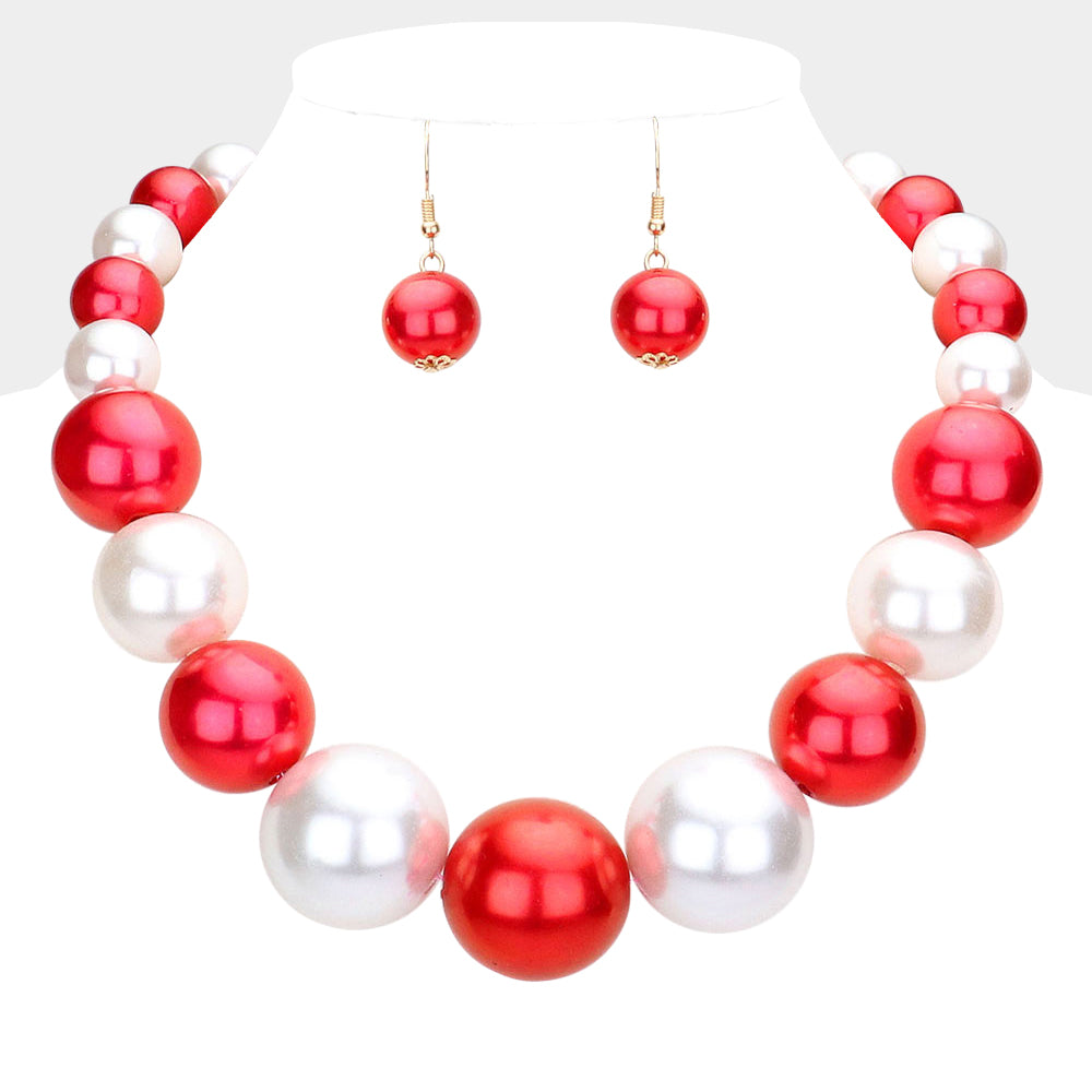 Red and White Oversized Graduated Pearl Glossy Statement Necklace Set on gold on a white background.