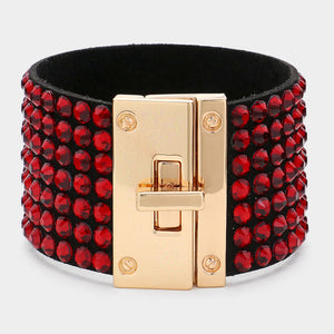 Red on black 7-row rhinestone bling studded bracelet with gold hardware on a white background