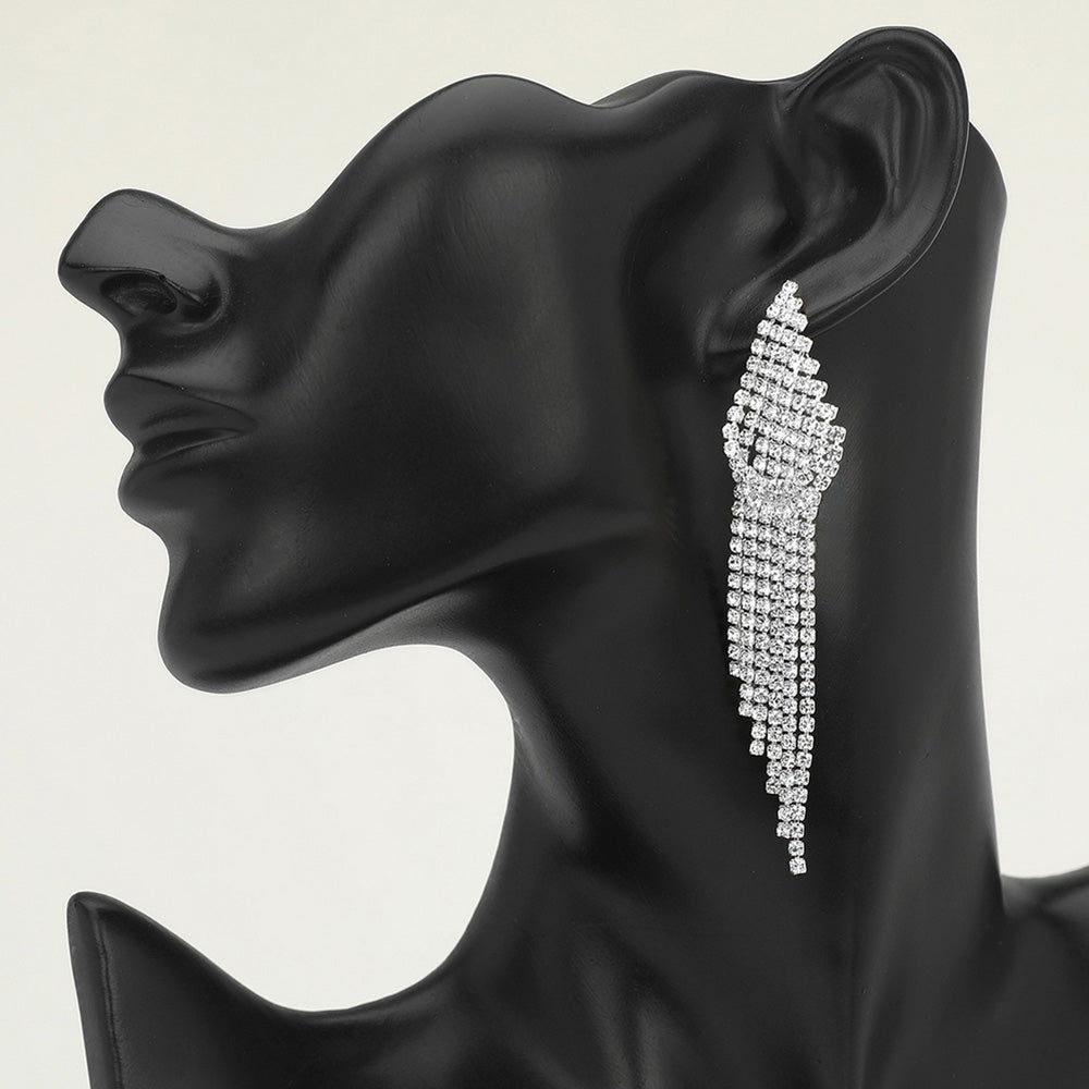 Long clear silver rhinestone cascade fringe drop earrings on a black mannequin ear — sparkling tassel statement jewelry for weddings, prom, and evening events.