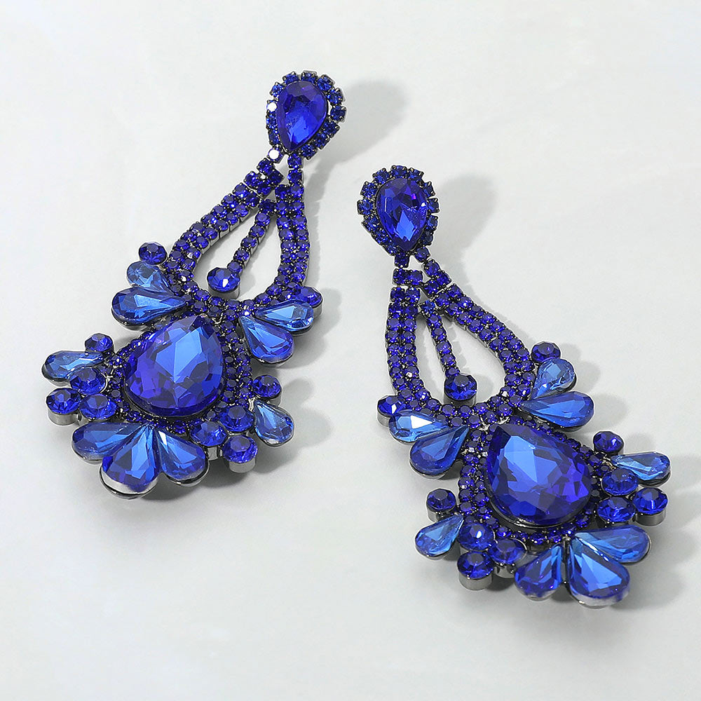 Sapphire royal blue teardrop chandelier statement earrings for pageant or prom evening wear on a white background