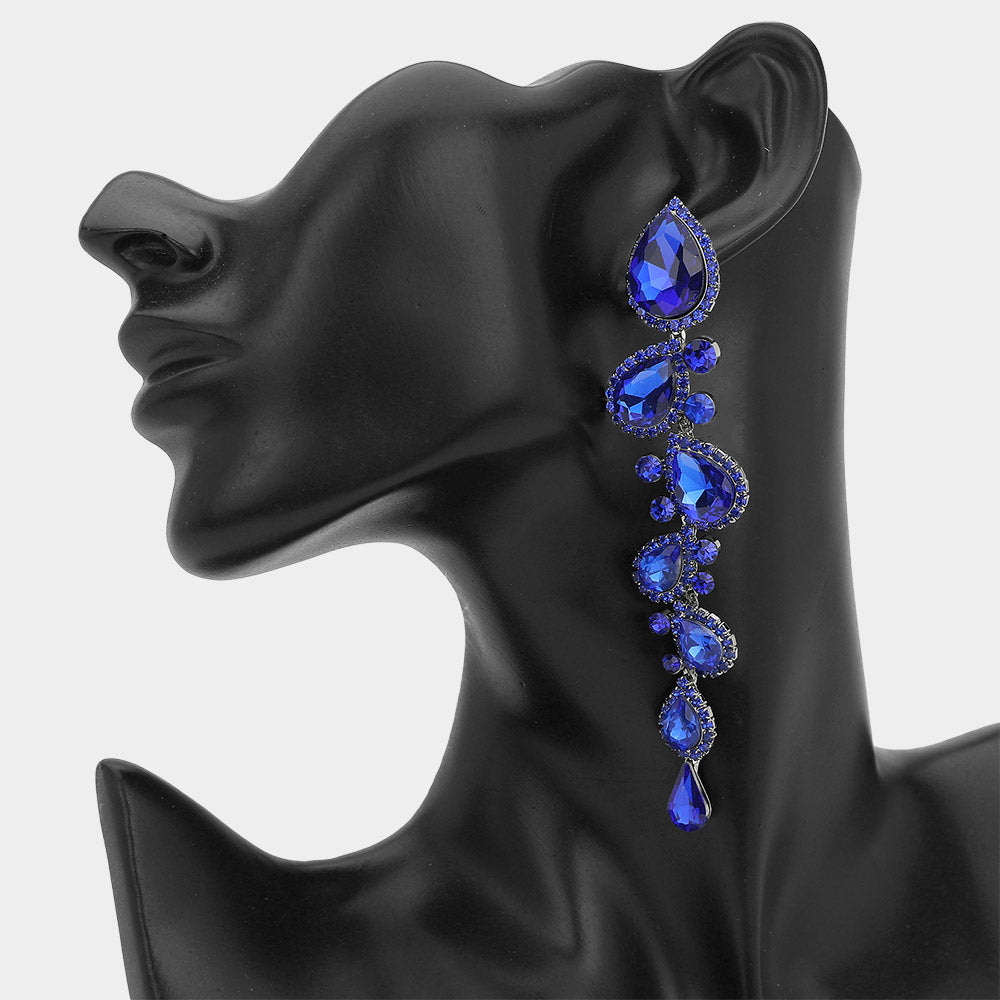 Royal blue sapphire long teardrop pageant earrings on silver backing with 4.3 inch drop shown on a black mannequin ear