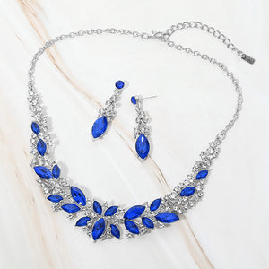 Royal Blue and clear marquise stone cluster prom and evening necklace set on silver on white marble background
