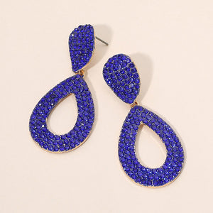Sapphire-Royal Blue rhinestone pavé cut out teardrop pageant earrings on gold with brilliant crystal sparkle on beige background.