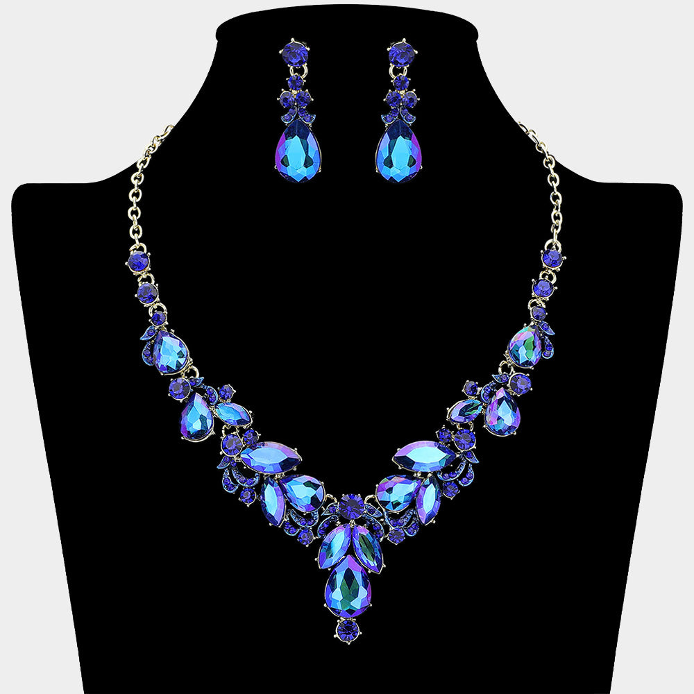 Sapphire AB rhinestone cluster necklace with teardrop gems and earrings on a black mannequin bust for pageant or prom