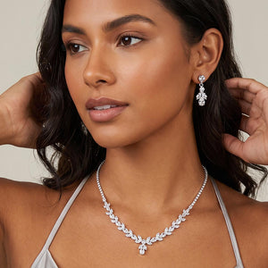 A model wearing Sapphire and clear crystal marquise necklace set on silver with matching drop earrings.