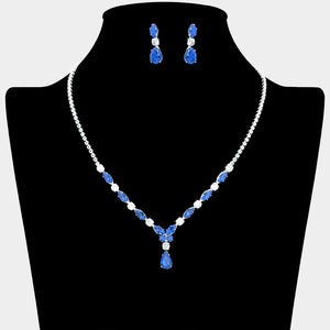 Sapphire and clear crystal dainty necklace set on silver with spaced crystal accents, a delicate center drop, and matching drop earrings, displayed on a black jewelry bust.