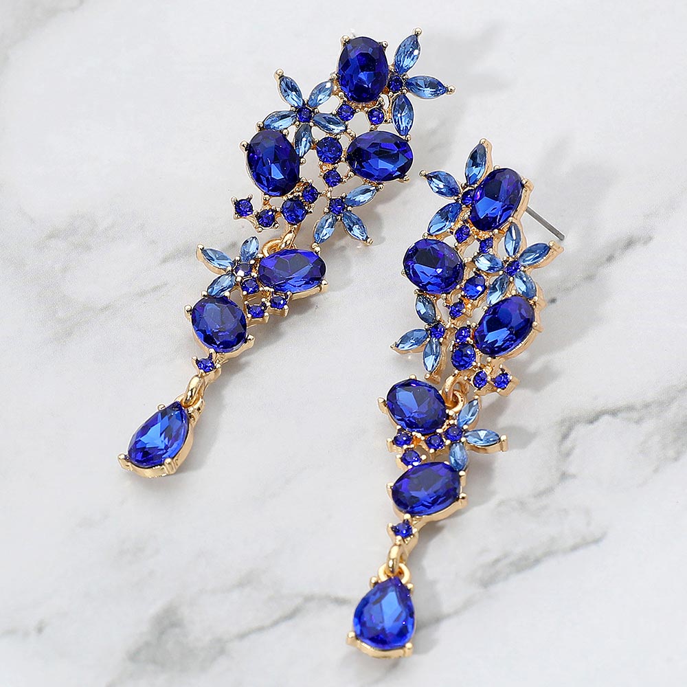 Sapphire floral cluster drop earrings with marquise and oval stones for interviews or evening glam on a marble background