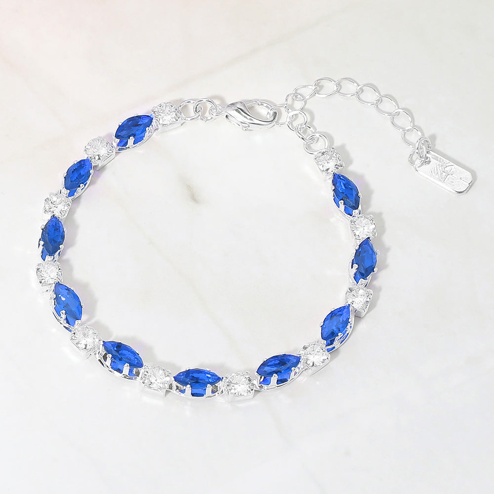 Sapphire marquise crystal prom bracelet on silver on white marble background