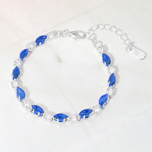 Sapphire marquise crystal prom bracelet on silver on white marble background