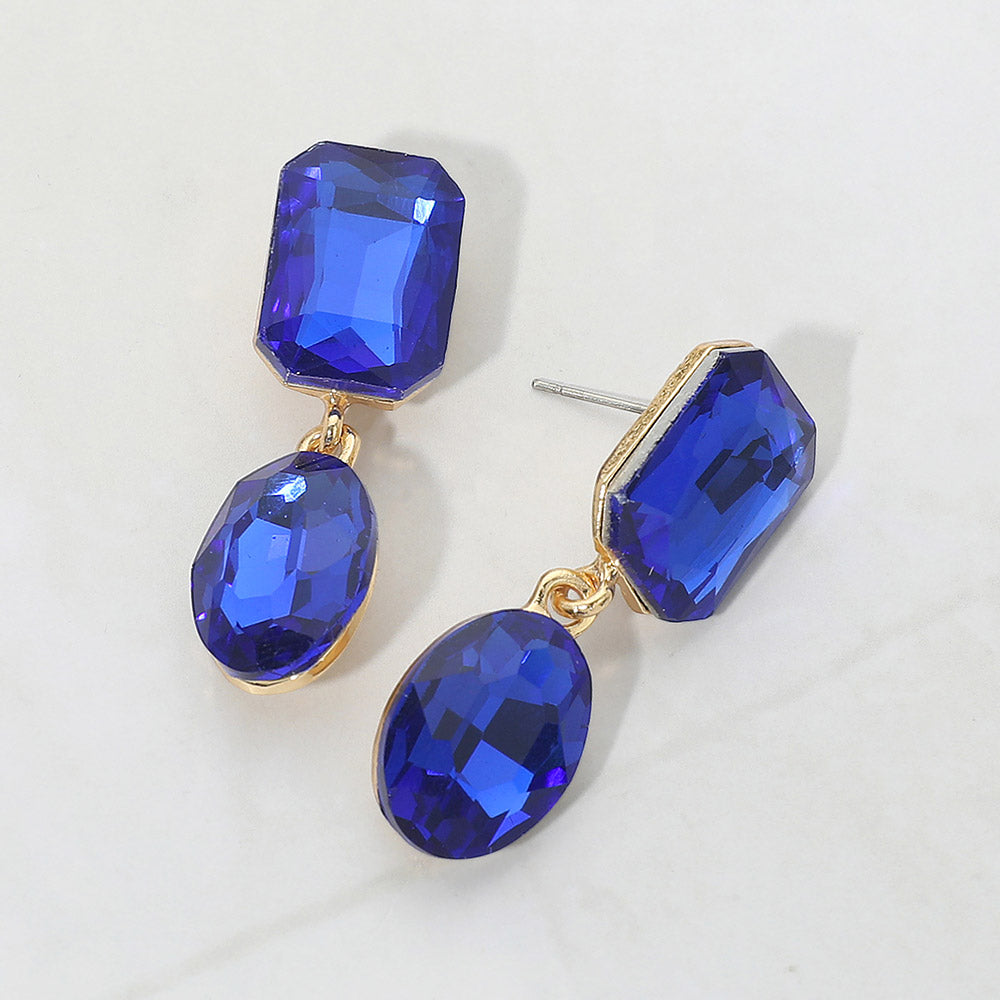 Violet Oval and Emerald Cut Stone Dangle Pageant Earrings on gold  | Interview Drop Earrings on Silver on a gray background