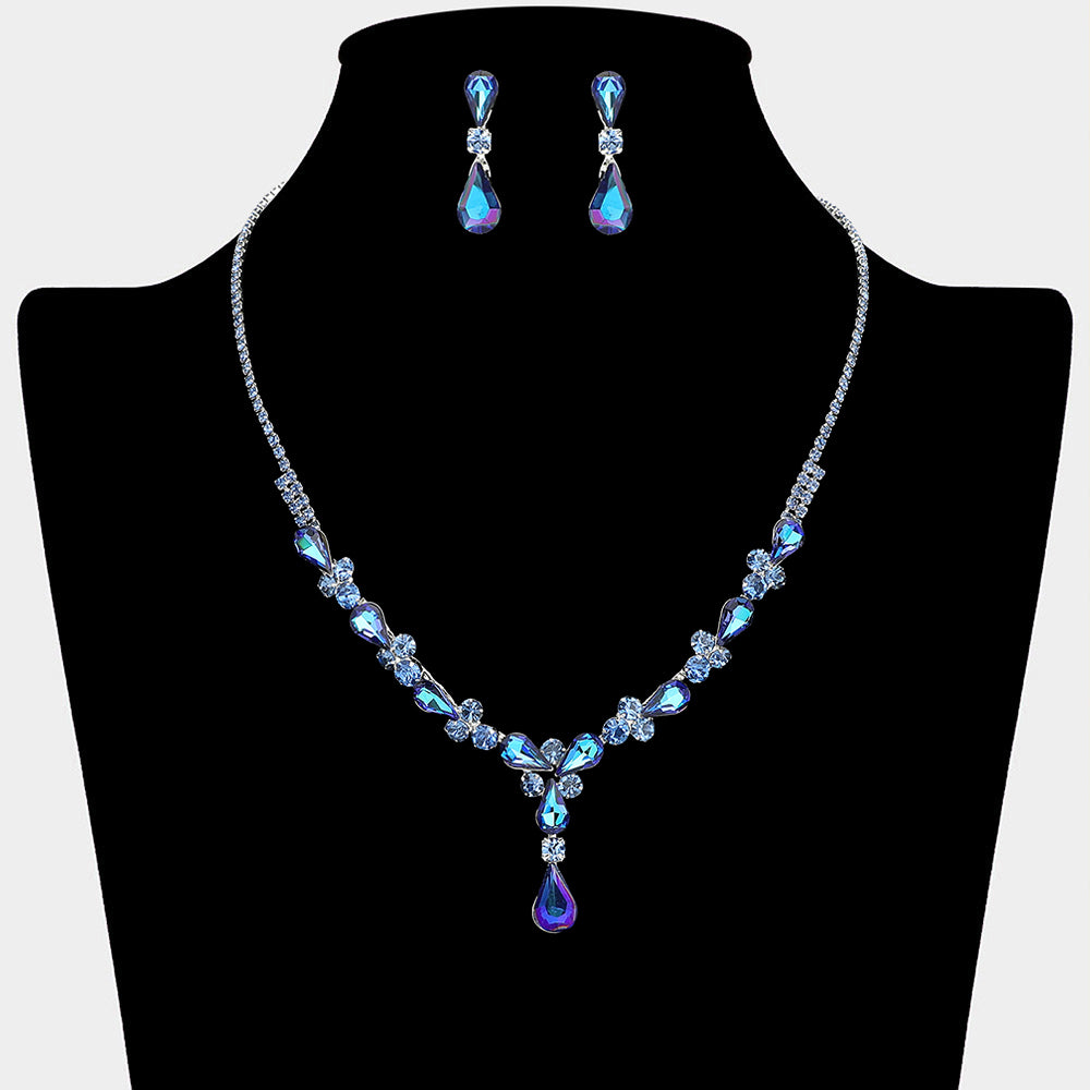 Sapphire teardrop crystal necklace set on silver with matching earrings for prom and evening wear on a black mannequin bust on a white background.