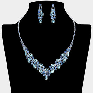 Light sapphire teardrop rhinestone necklace set with V-shaped crystal design and matching earrings, all backed in silver, for prom and formal wear. Shown on a black mannequin bust.  