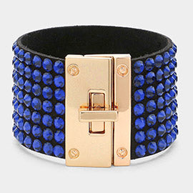 Sapphire (royal blue) on black 7-row rhinestone bling studded bracelet with gold hardware on a white background