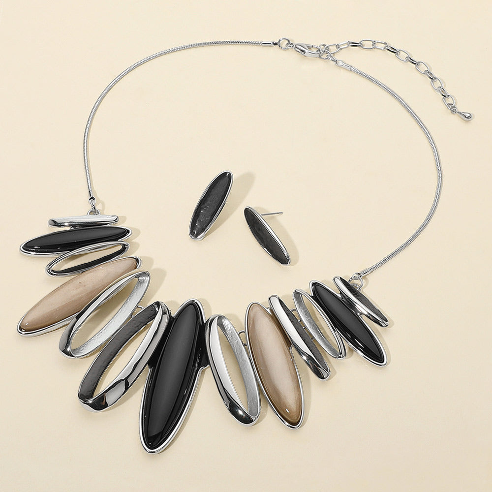 Shades of Black and Taupe with metal marquise stones statement necklace on a white mannequin bust
