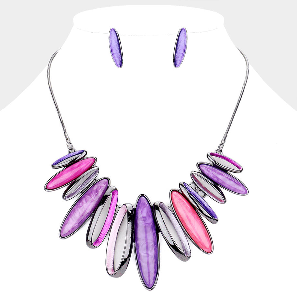 Shades of purple with metal marquise stones statement necklace on a white mannequin bust