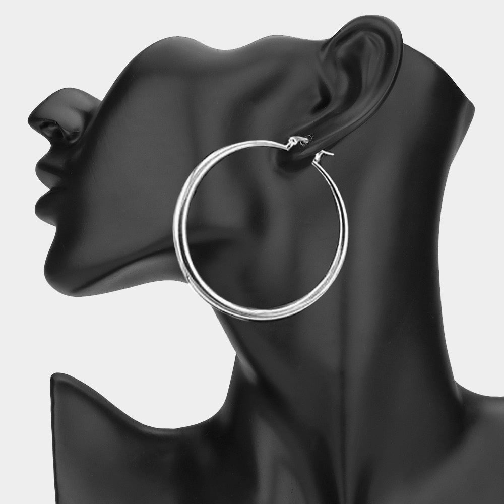 Silver 2.5-inch hoop earring with pin catch clasp, displayed on a black mannequin ear.
