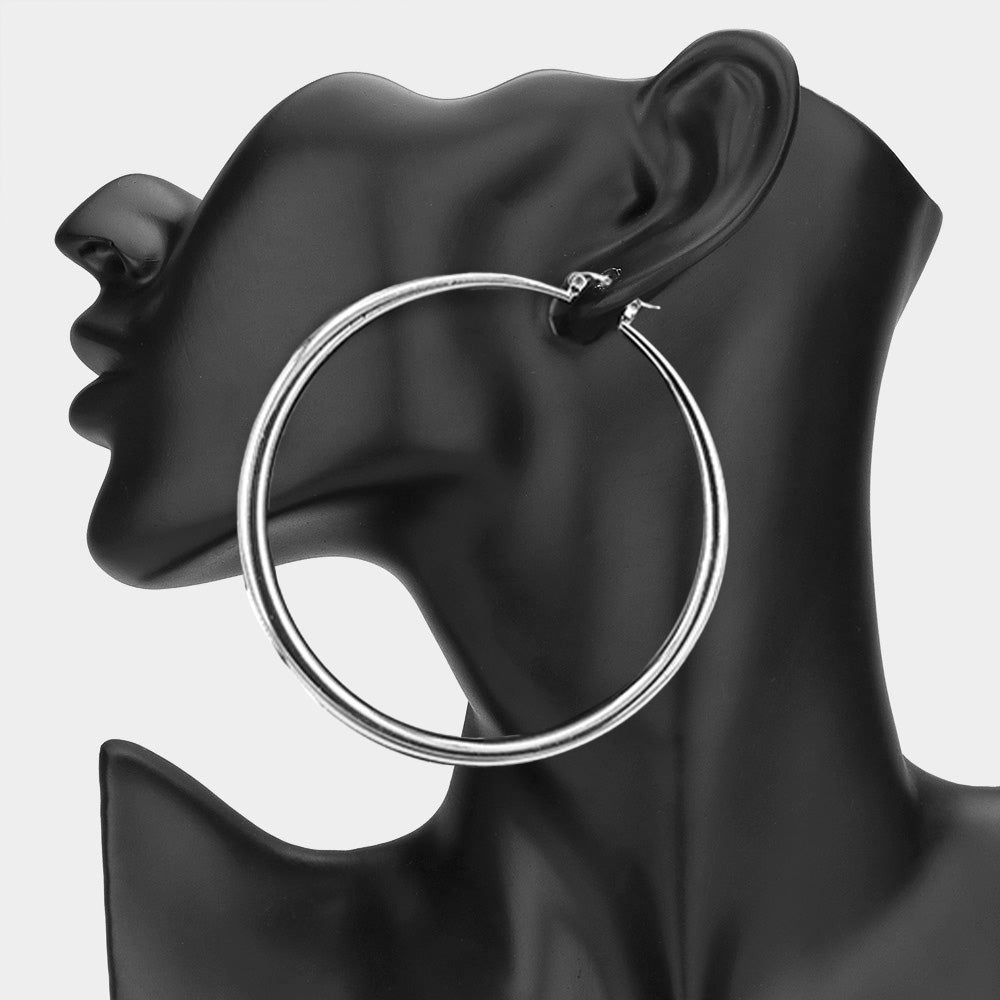 Large silver 3.25-inch hoop earring with pin catch clasp, displayed on a black mannequin ear.