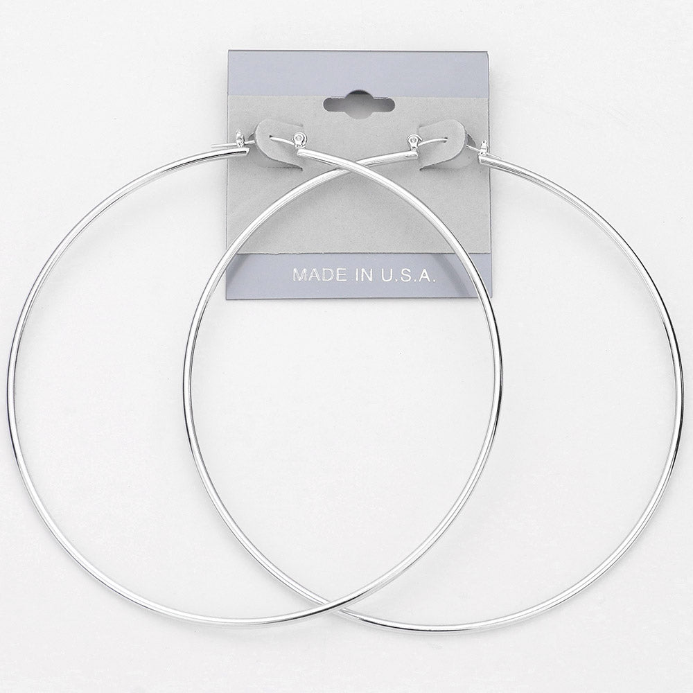 Oversized silver hoop earrings with a 3.6-inch diameter and pin catch clasp, displayed on a light gray background.