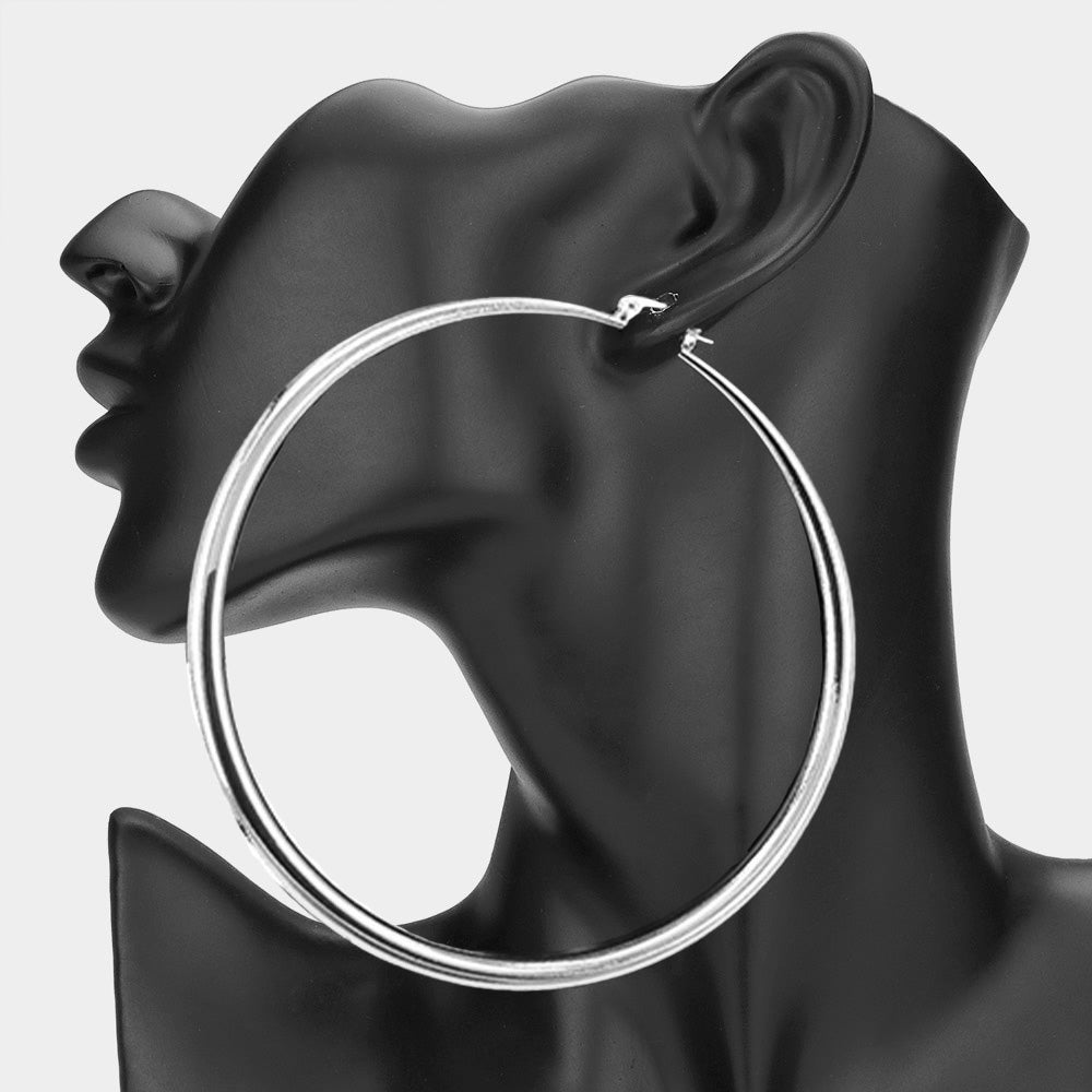 Oversized Silver 4-inch hoop earring with slide-in wire closure, displayed on a black mannequin ear.