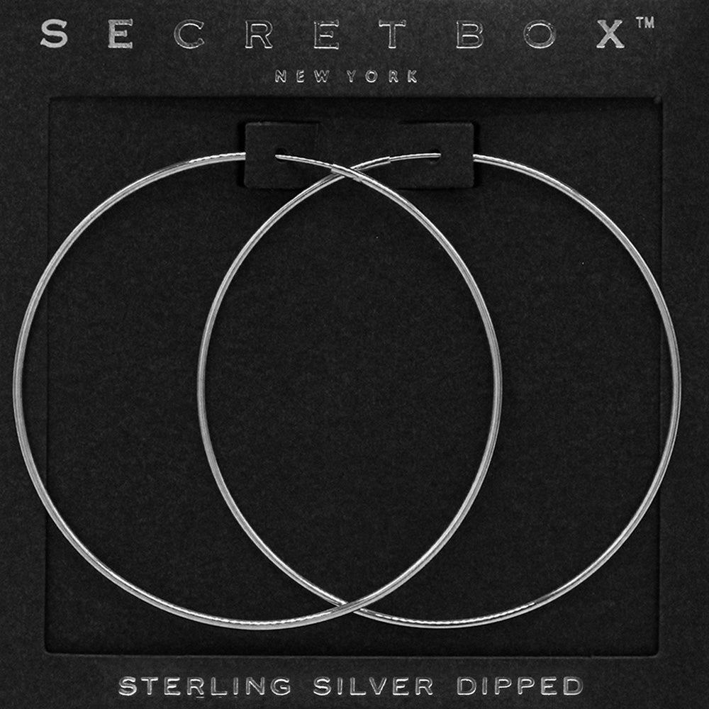 Silver wire hoop earrings with a 2.25-inch diameter displayed on a black jewelry card.