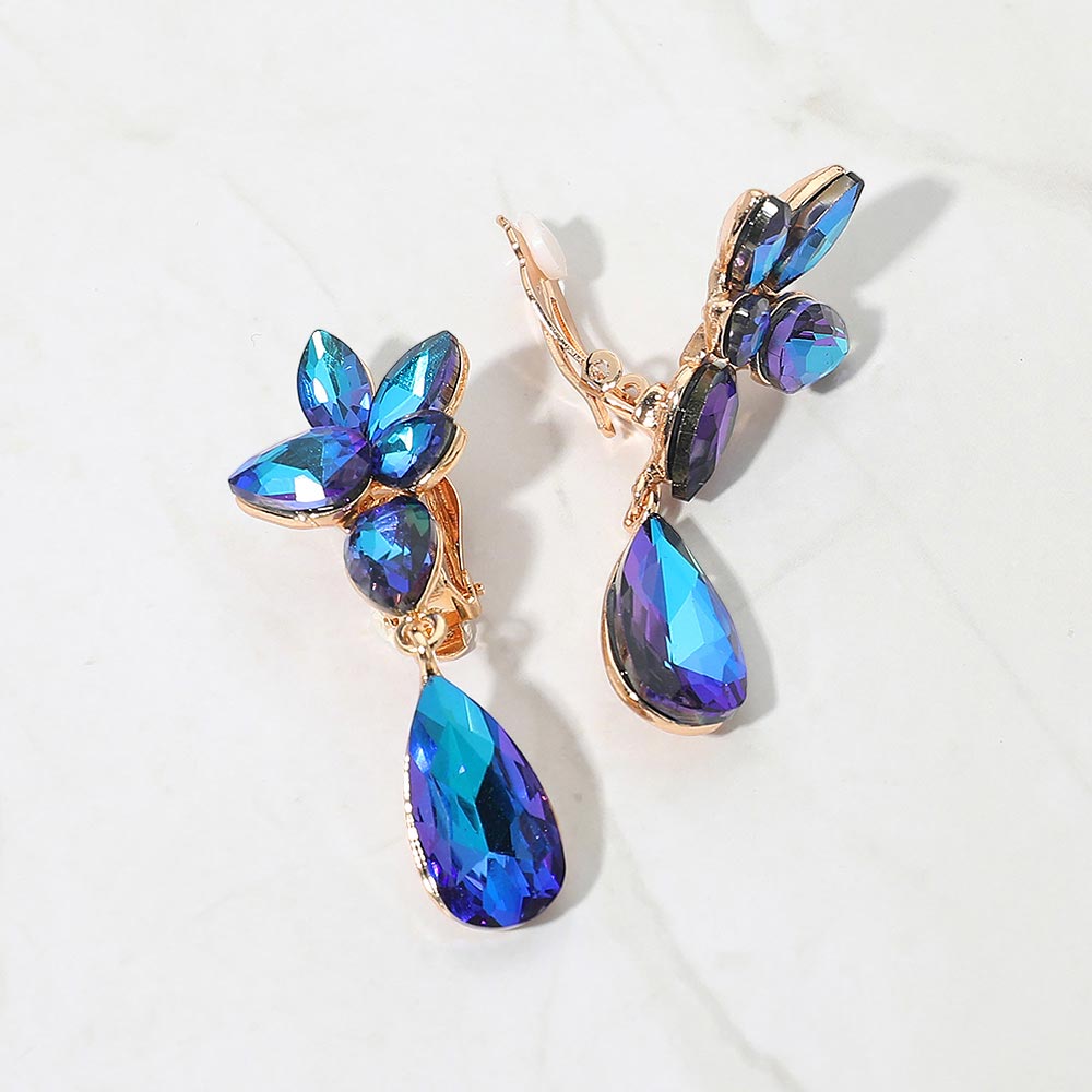 Slim Blue AB crystal teardrop clip-on earrings on gold on white marble background