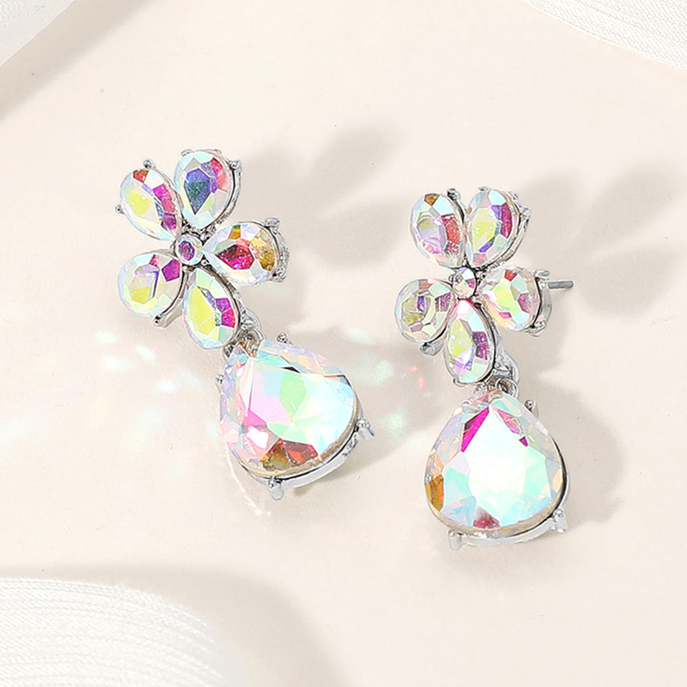 AB flower and teardrop rhinestone earrings with iridescent sparkle for prom or pageant wear on a cream colored background