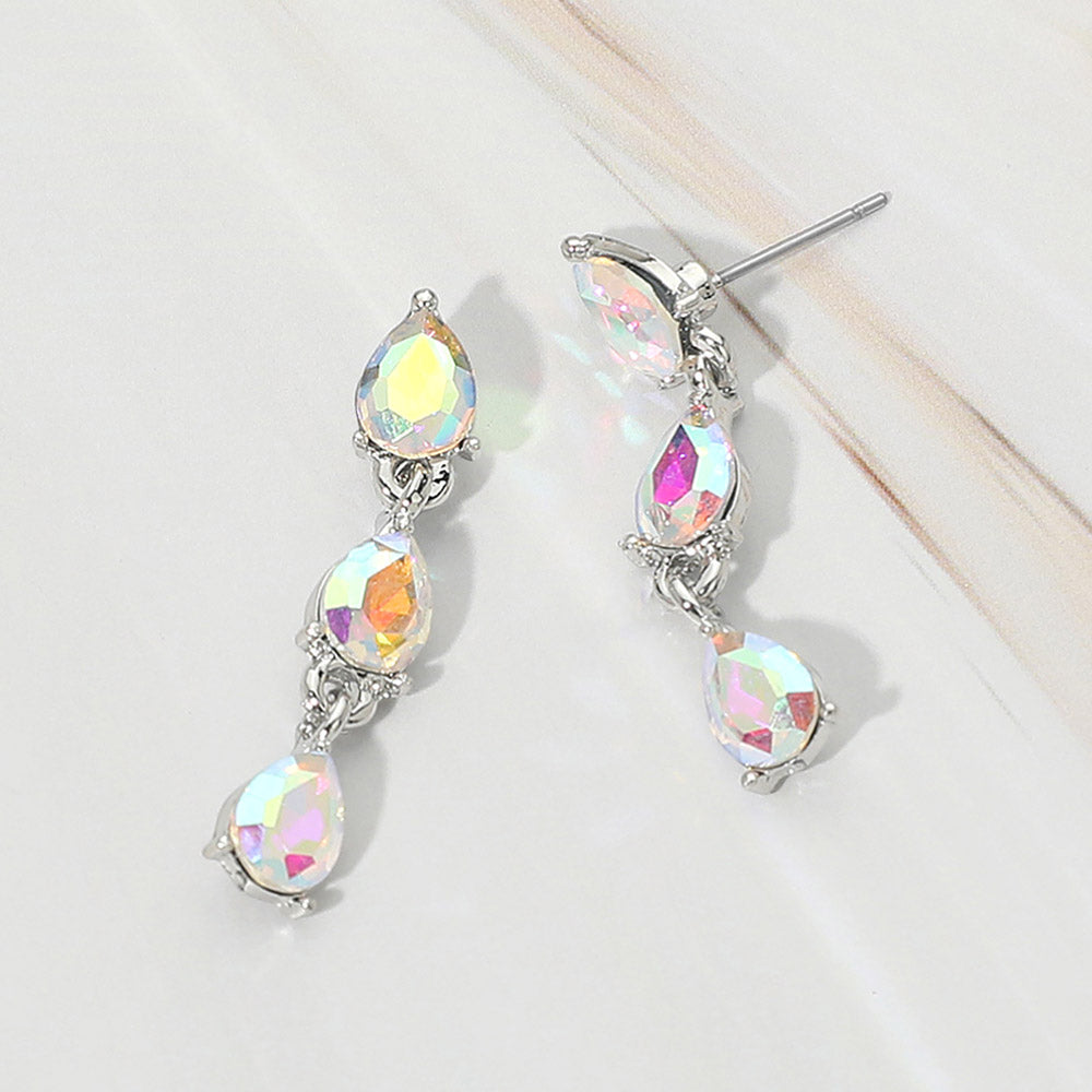 Small AB iridescent triple teardrop cluster drop earrings on silver on a white marble background