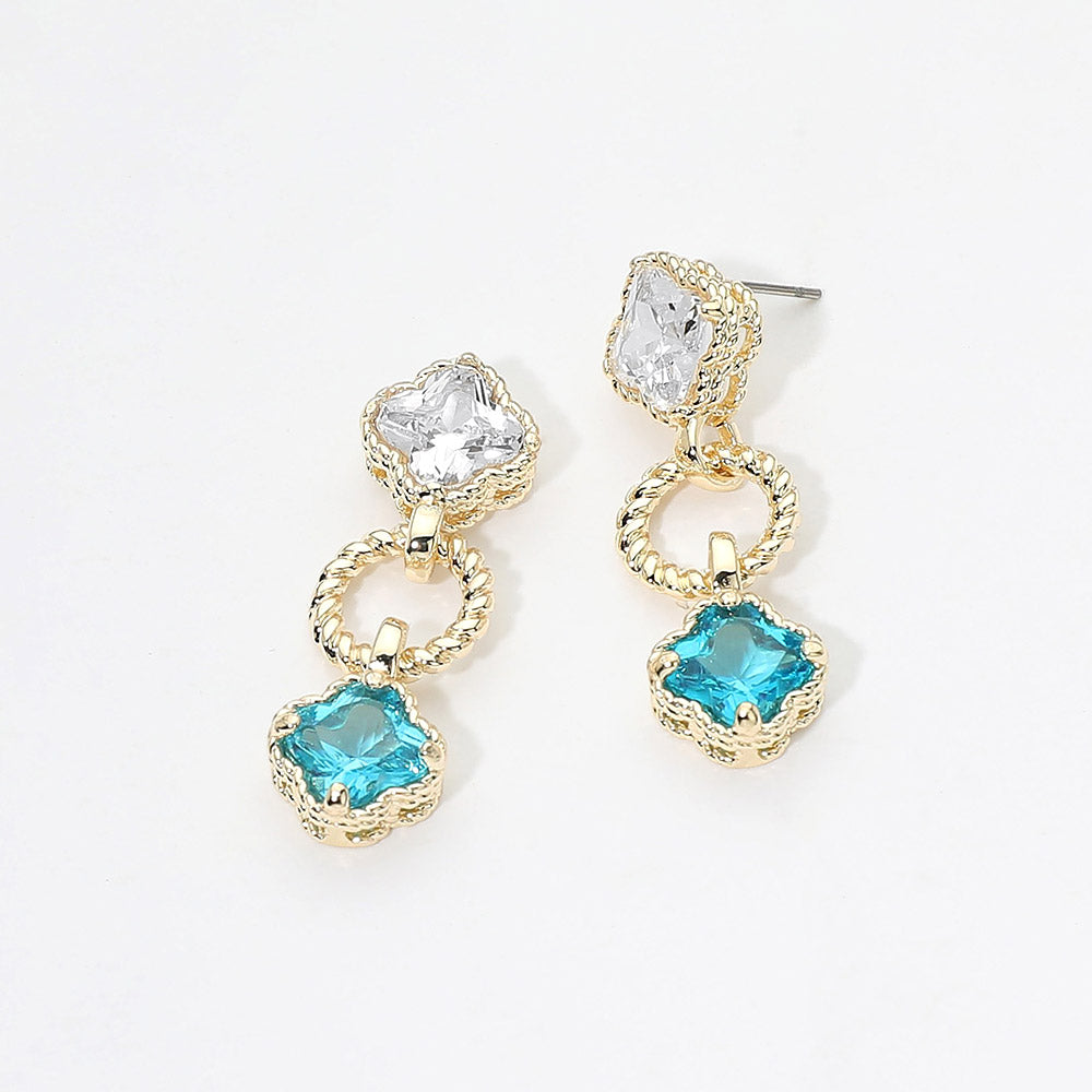 Small aqua and clear crystal drop earrings on gold featuring a clear round crystal above a vintage-inspired aqua cushion-shaped crystal with delicate beaded detailing, displayed on a white jewelry card.