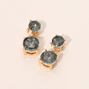 Small smoky gray double round little girls pageant drop earrings on gold on a beige background
