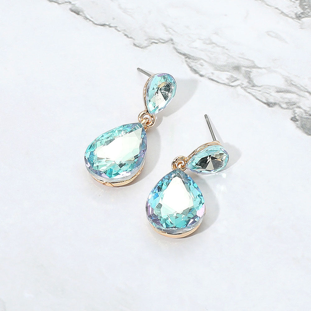 Small Blue AB Crystal Teardrop Dangle Earrings on Gold | Little Girls | Older Girls Interview on a marble background