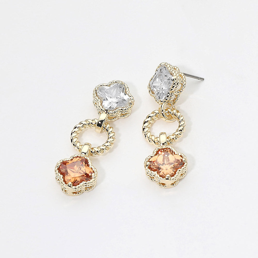 Small champagne gold stone and clear crystal drop earrings on gold featuring a clear round crystal above a vintage-inspired champagne gold cushion-shaped crystal with delicate beaded detailing, displayed on a white jewelry card.