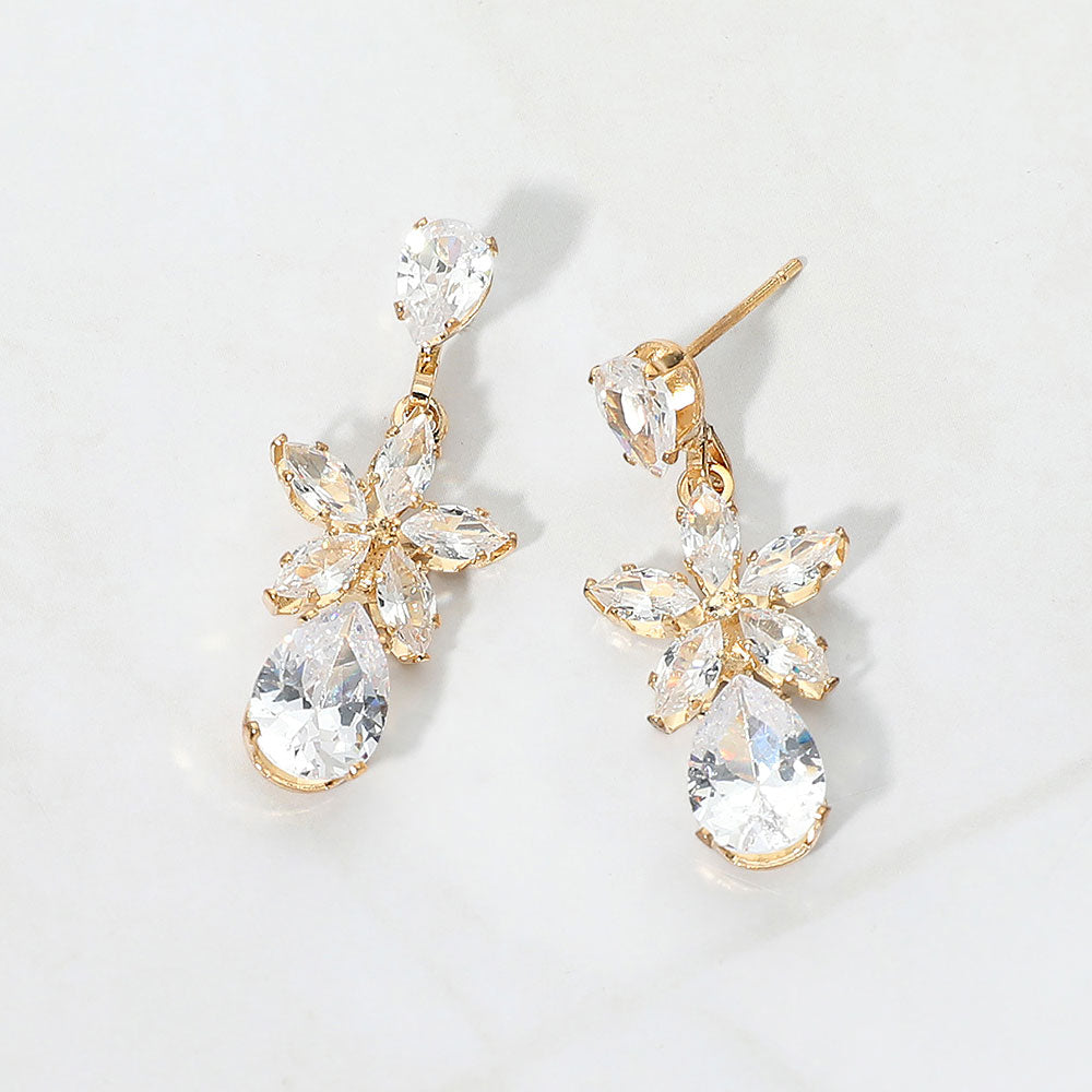 Small clear crystal floral teardrop pageant earrings for little girls on gold on white background