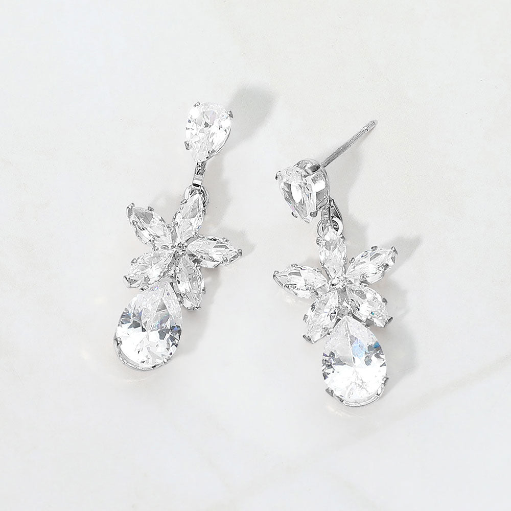 Small clear crystal floral teardrop pageant earrings for little girls on silver on white background