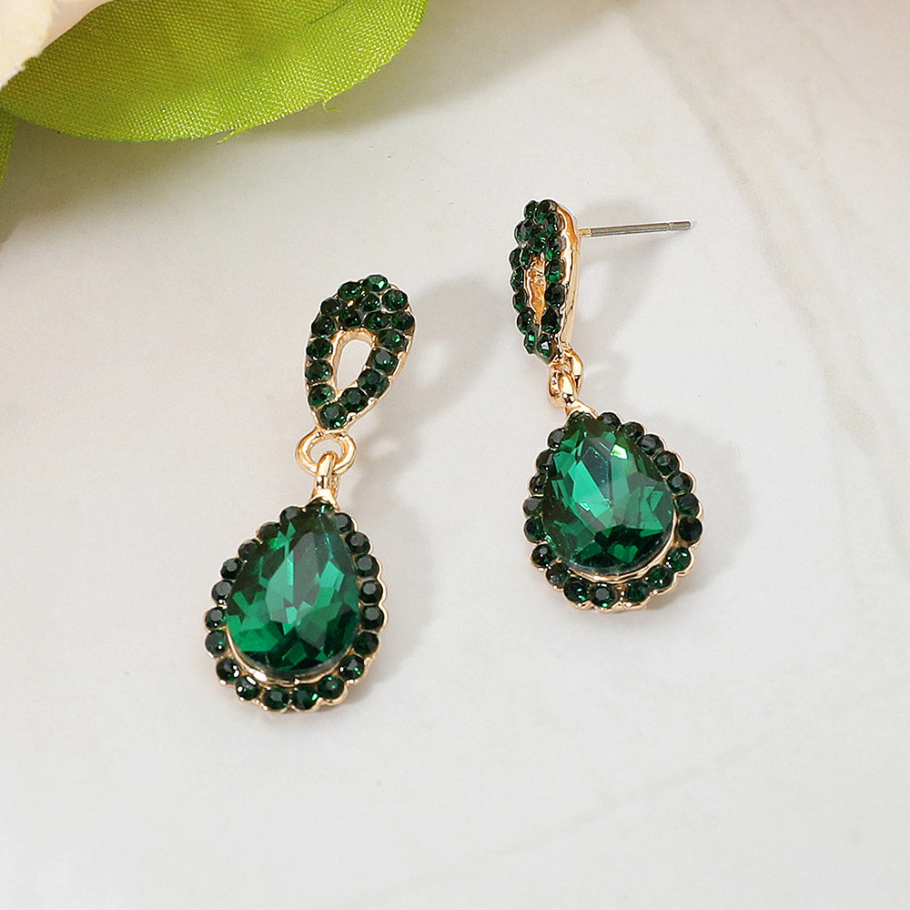 Emerald green teardrop rhinestone earrings gold backed on a white background for pageant interviews or winter formals