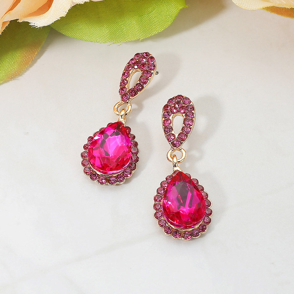 Fuchsia teardrop earrings with rhinestones, gold oval links on a white background for prom or pageant wear