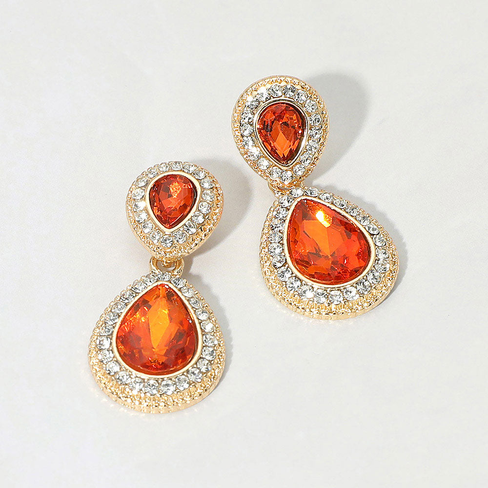 Small orange double teardrop crystal earrings on gold with rhinestones on white background