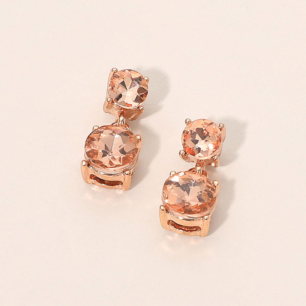 Small peach double round little girls pageant drop earrings on rose gold on a beige background