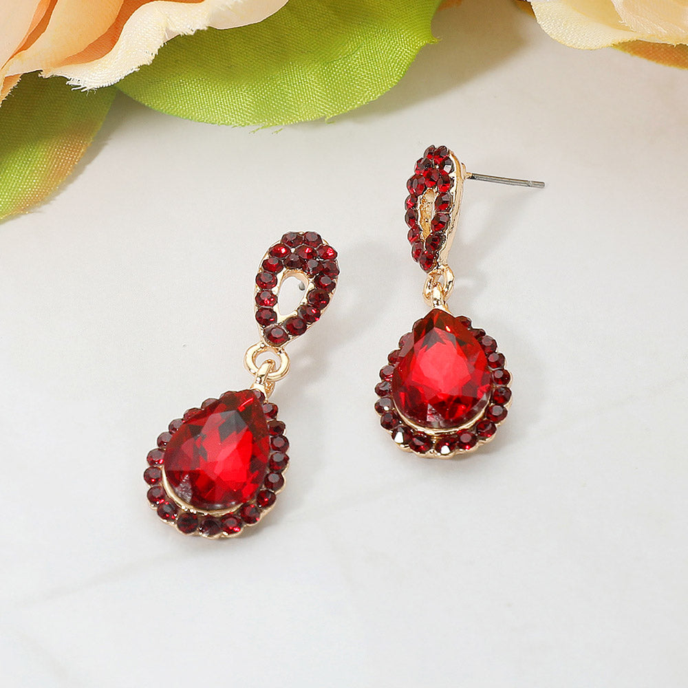 Red crystal teardrop dangle earrings with rhinestone accents on a white background for pageant or prom