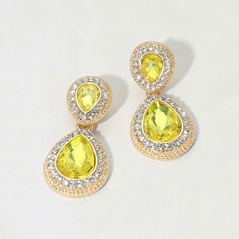 Small yellow double teardrop crystal earrings on gold with rhinestones on white background
