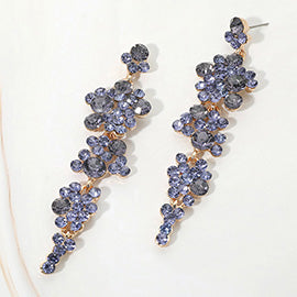 Pair of tanzanite blue/purple floral earrings on a white marble background