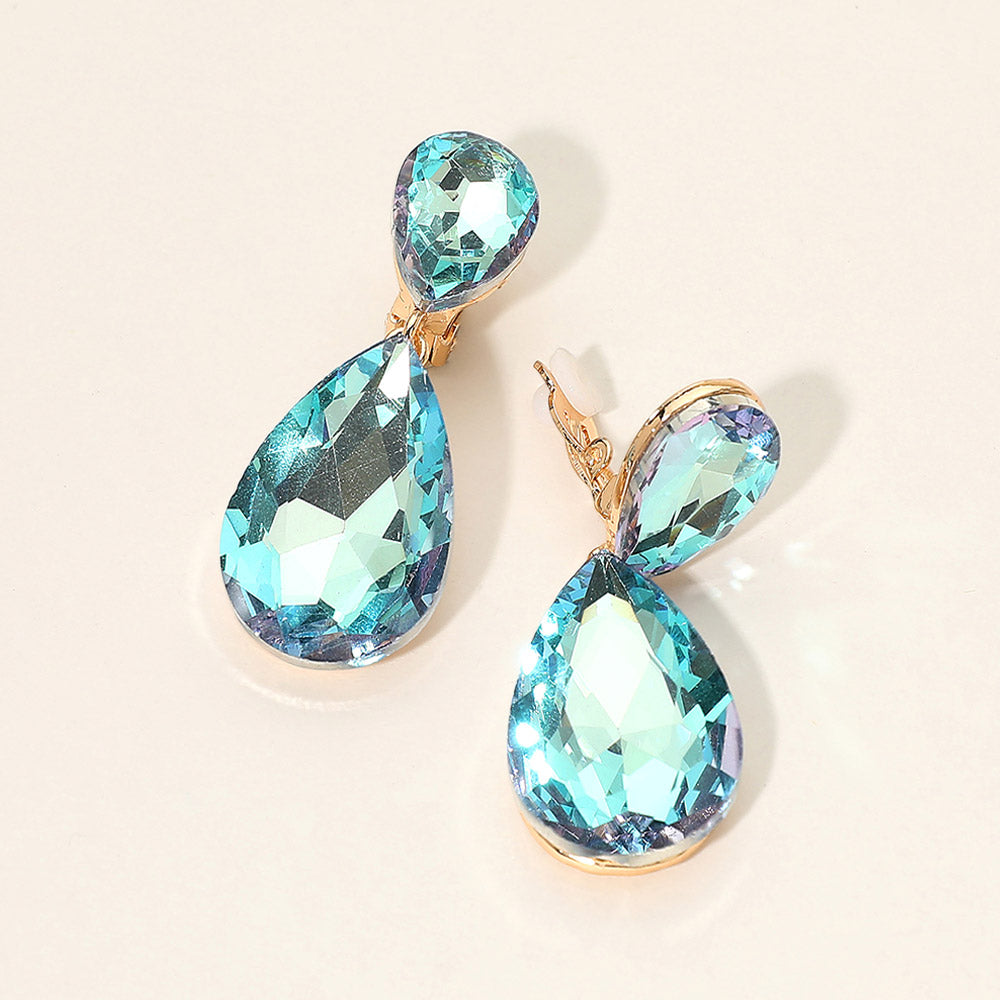 Teardrop-shaped blue gemstone clip on earrings on a light background