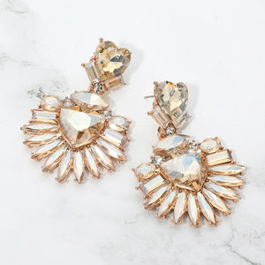 Champagne Gold Stone Heart Crystal Fan pageant and prom earrings on gold displayed on a white marble background