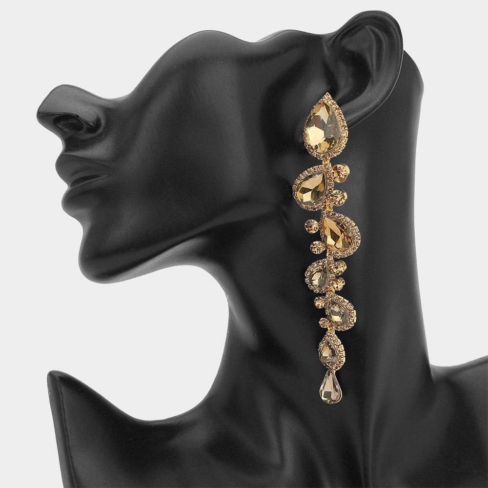 Topaz gold stone long teardrop pageant earrings on gold backing with 4.3 inch drop shown on a black mannequin ear
