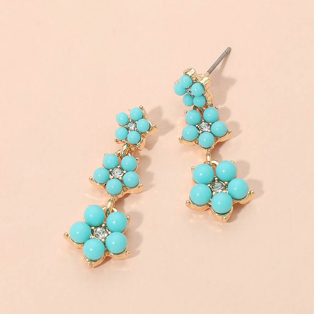 Turquoise floral cluster bridal drop earrings in a gold setting on a white background