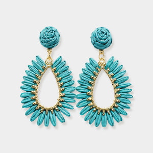 Turquoise woven raffia open teardrop earrings on gold with post backs isolated on a white background.