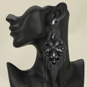 Very large smoky grey crystal flower fringe pageant earrings with 5.5 inch drop shown on a black mannequin ear