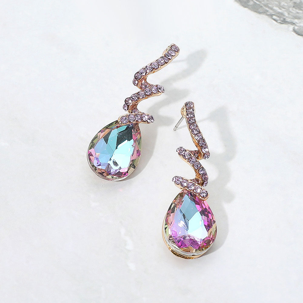 Violet teardrop swirl crystal earrings for little girls pageant or beauty walk wear on a white background.